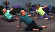 john schlorholtz and 2 students on floor doing yoga pose